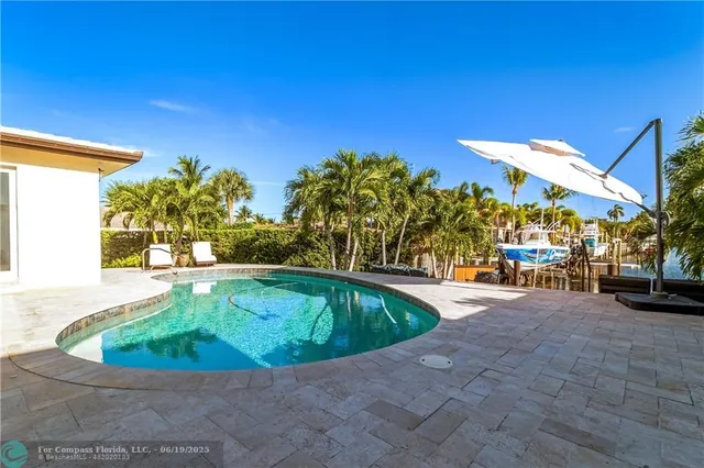 a view of a house with swimming pool and sitting area