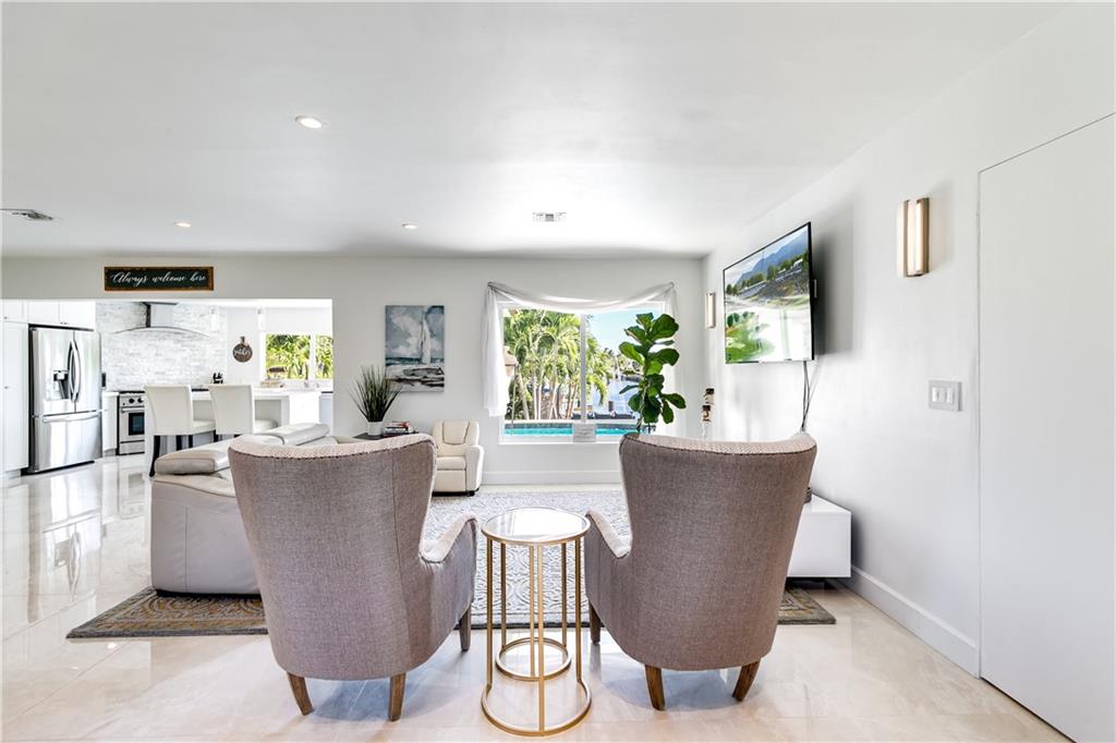 2948 Northeast 35th Court Lighthouse Point, FL 33064 - Photo 7 of 24 a living room with couches and a potted plant