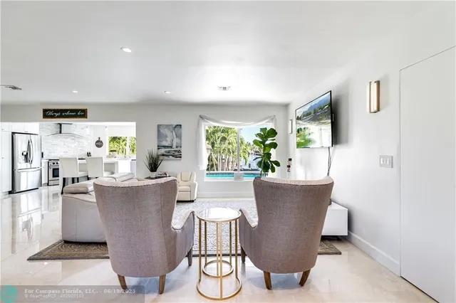 a living room with couches and a potted plant