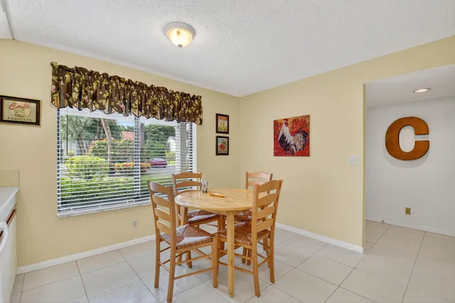 a dining room with furniture and a window