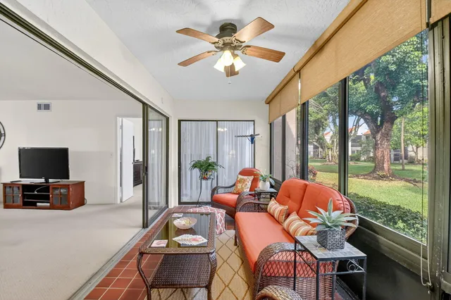 a living room with furniture and floor to ceiling windows