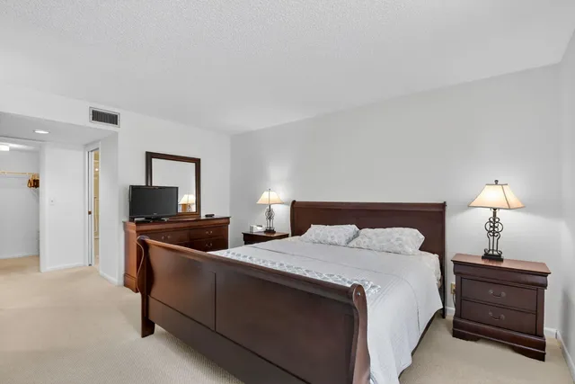 a bed room with two bed and a lamp