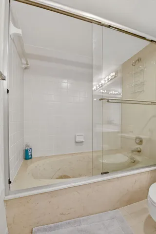 a bathroom with a bathtub and a shower