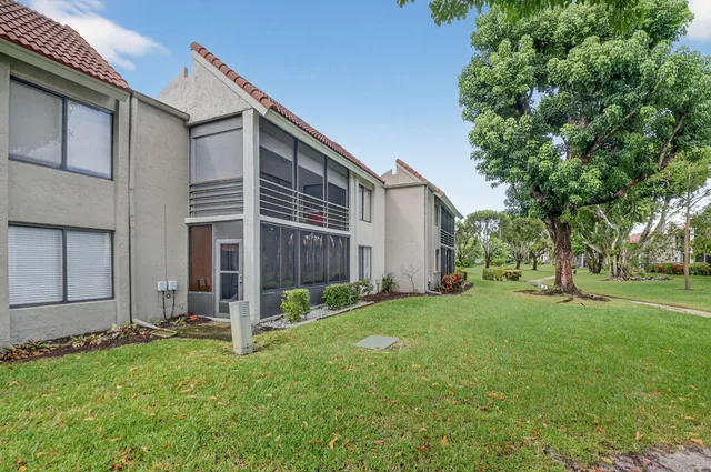 a view of backyard with large trees and a small yard