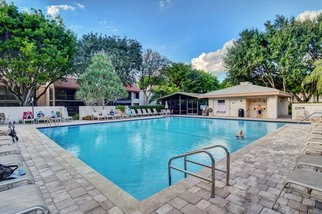 a view of backyard with deck and outdoor seating