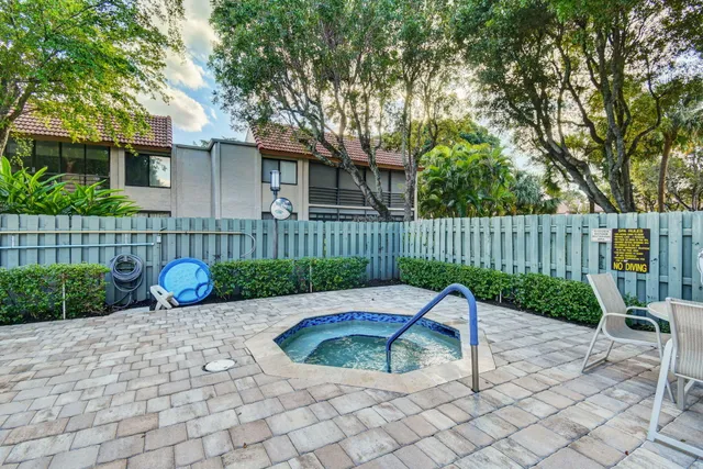 a sign board with tall trees