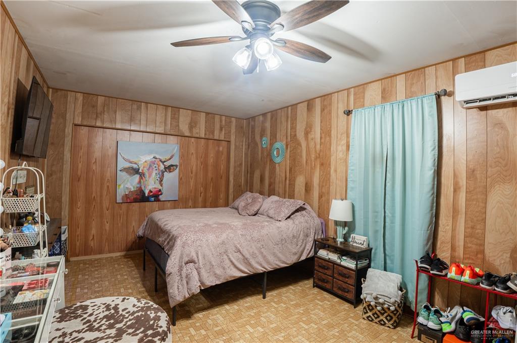 425 South Reynolds Rio Hondo, TX 78583 - Photo 12 of 23 This room features wood-paneled walls and a ceiling fan with integrated lighting