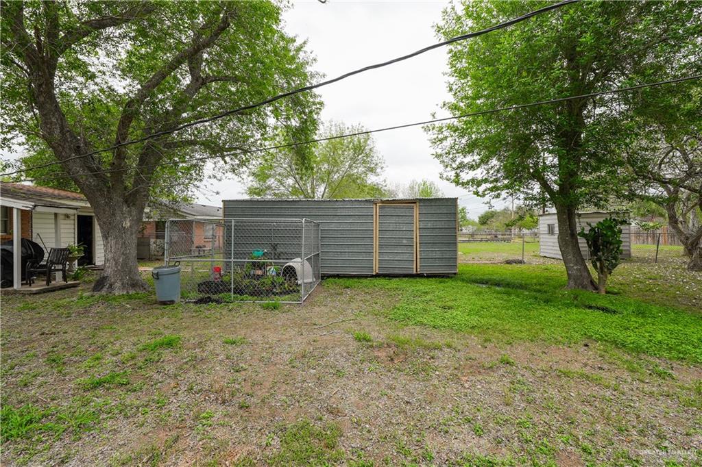 425 South Reynolds Rio Hondo, TX 78583 - Photo 20 of 23 The property features a spacious yard with mature trees and a detached shed