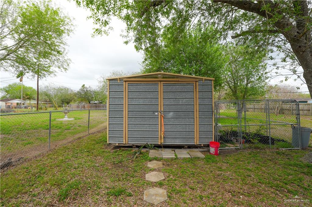 425 South Reynolds Rio Hondo, TX 78583 - Photo 21 of 23 The property features a durable metal shed with double doors, providing functional outdoor storage