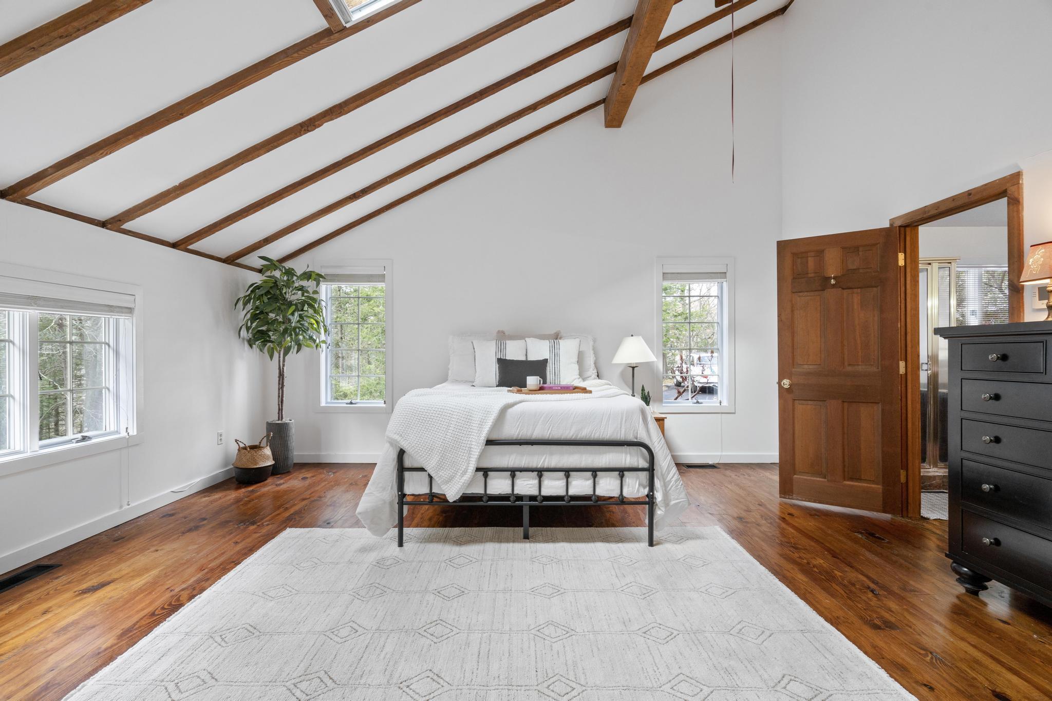 381 West Mountain Road Ridgefield, CT 06877 - Photo 21 of 35 a spacious bedroom with a bed and wooden floor