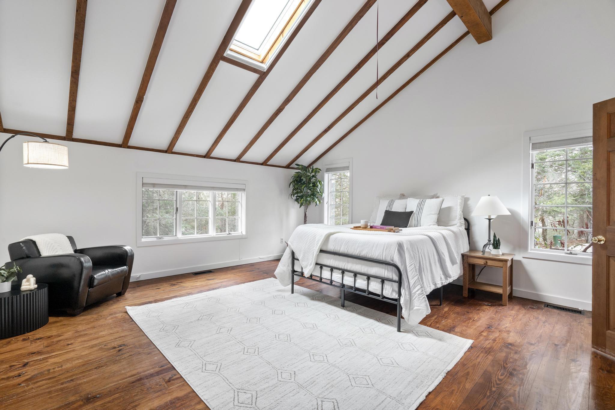 381 West Mountain Road Ridgefield, CT 06877 - Photo 22 of 35 a spacious bedroom with a bed and wooden floor