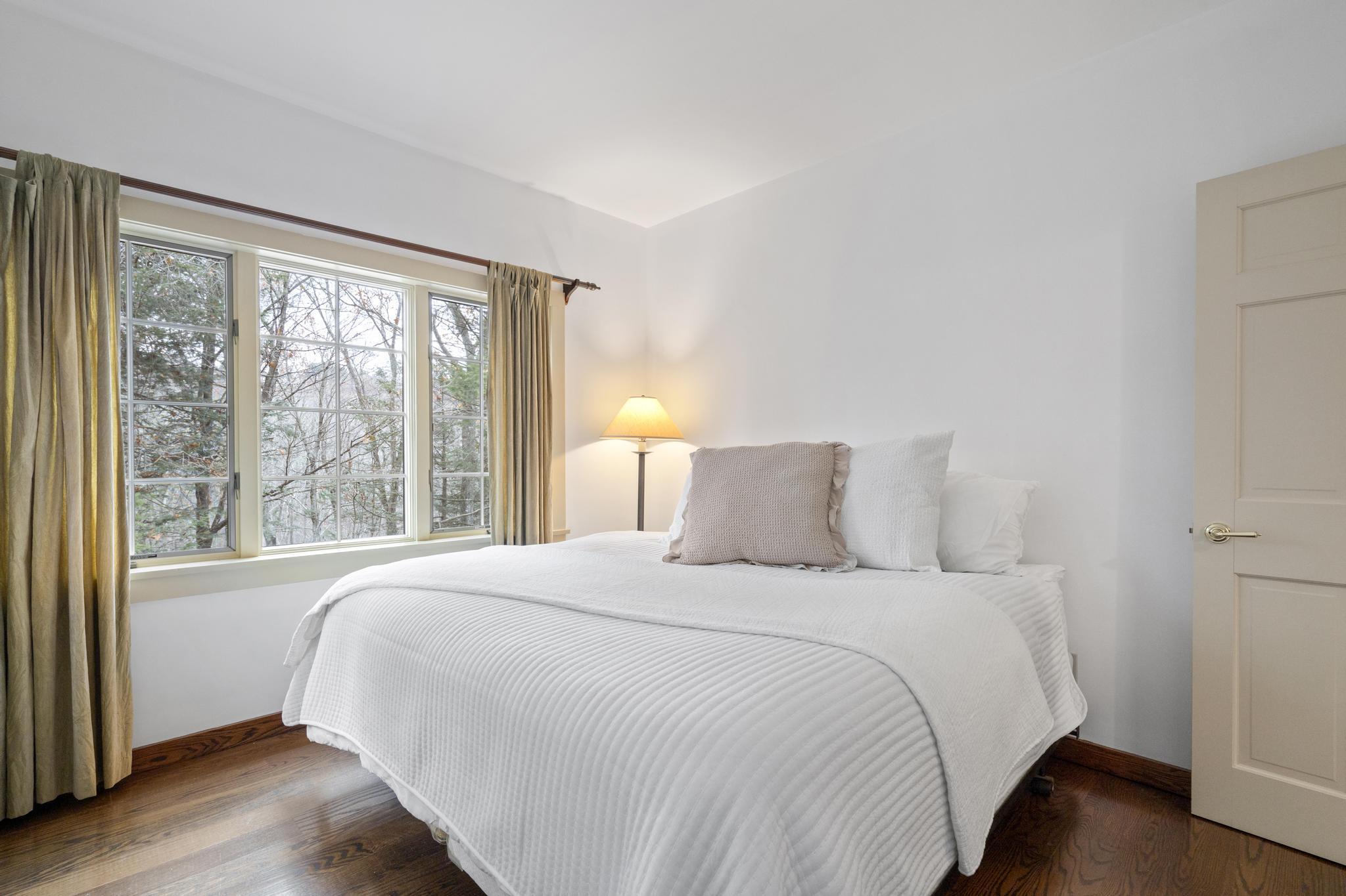 381 West Mountain Road Ridgefield, CT 06877 - Photo 26 of 35 a bedroom with a large bed and a large window