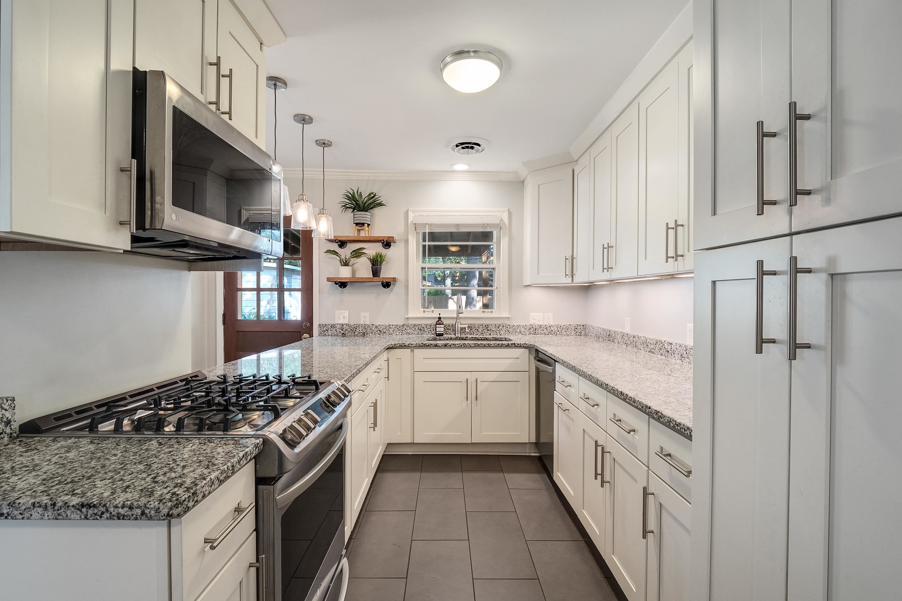 1216 West Perkins Road Memphis, TN 38117 - Photo 12 of 30 a kitchen with stainless steel appliances granite countertop a stove and a sink