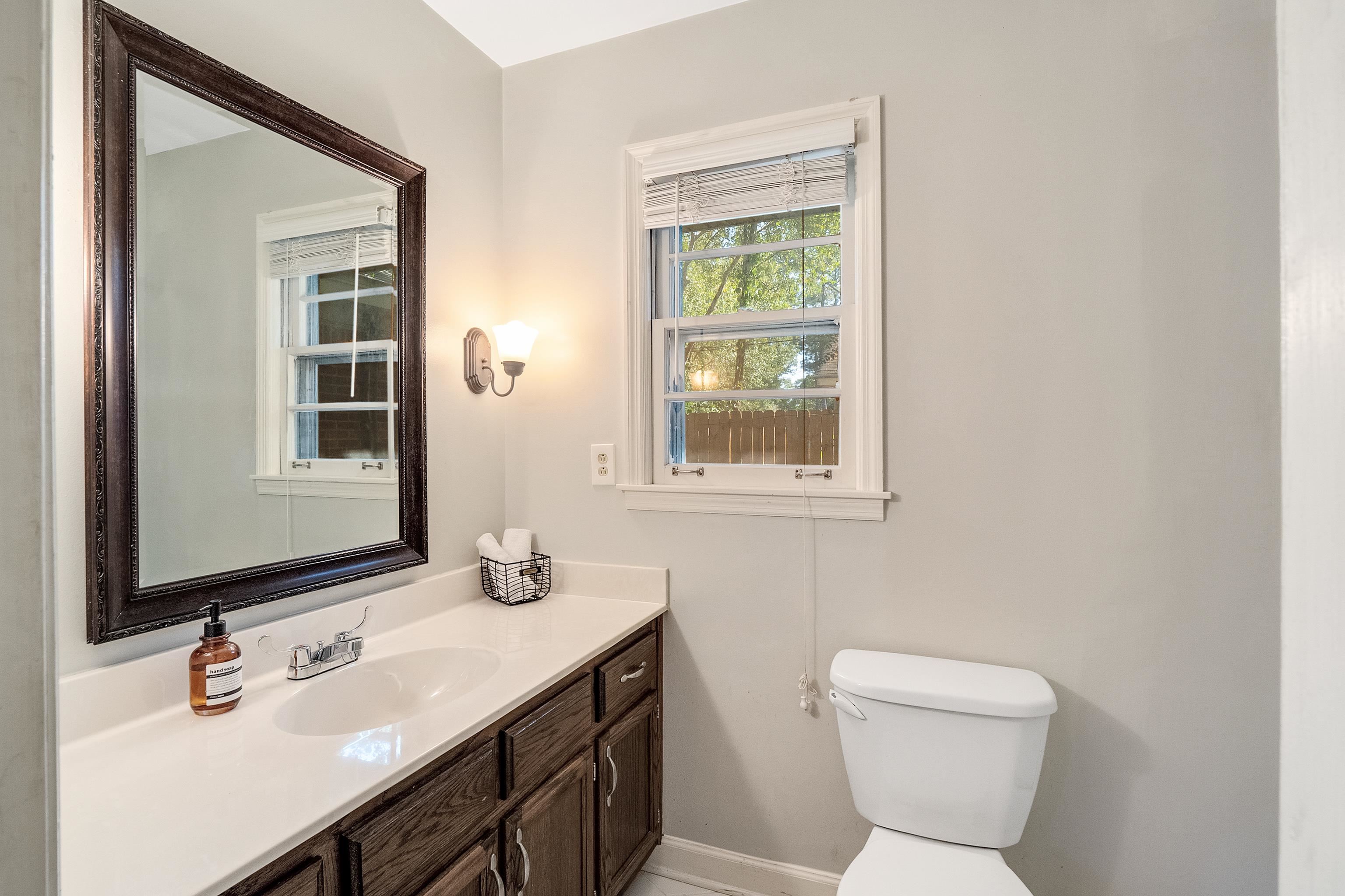 1216 West Perkins Road Memphis, TN 38117 - Photo 19 of 30 a bathroom with a toilet sink and mirror