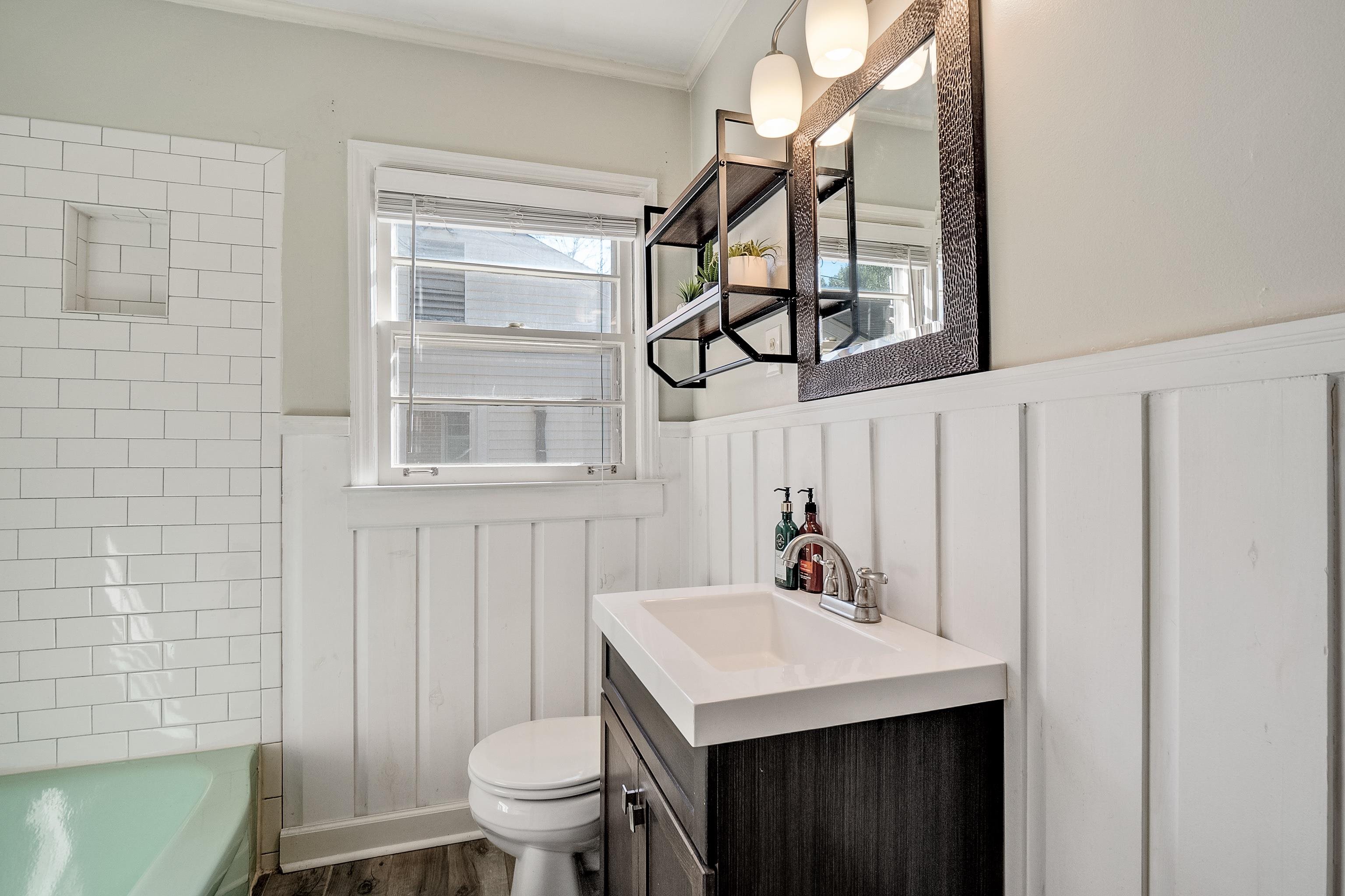1216 West Perkins Road Memphis, TN 38117 - Photo 24 of 30 a bathroom with a sink a toilet and a mirror