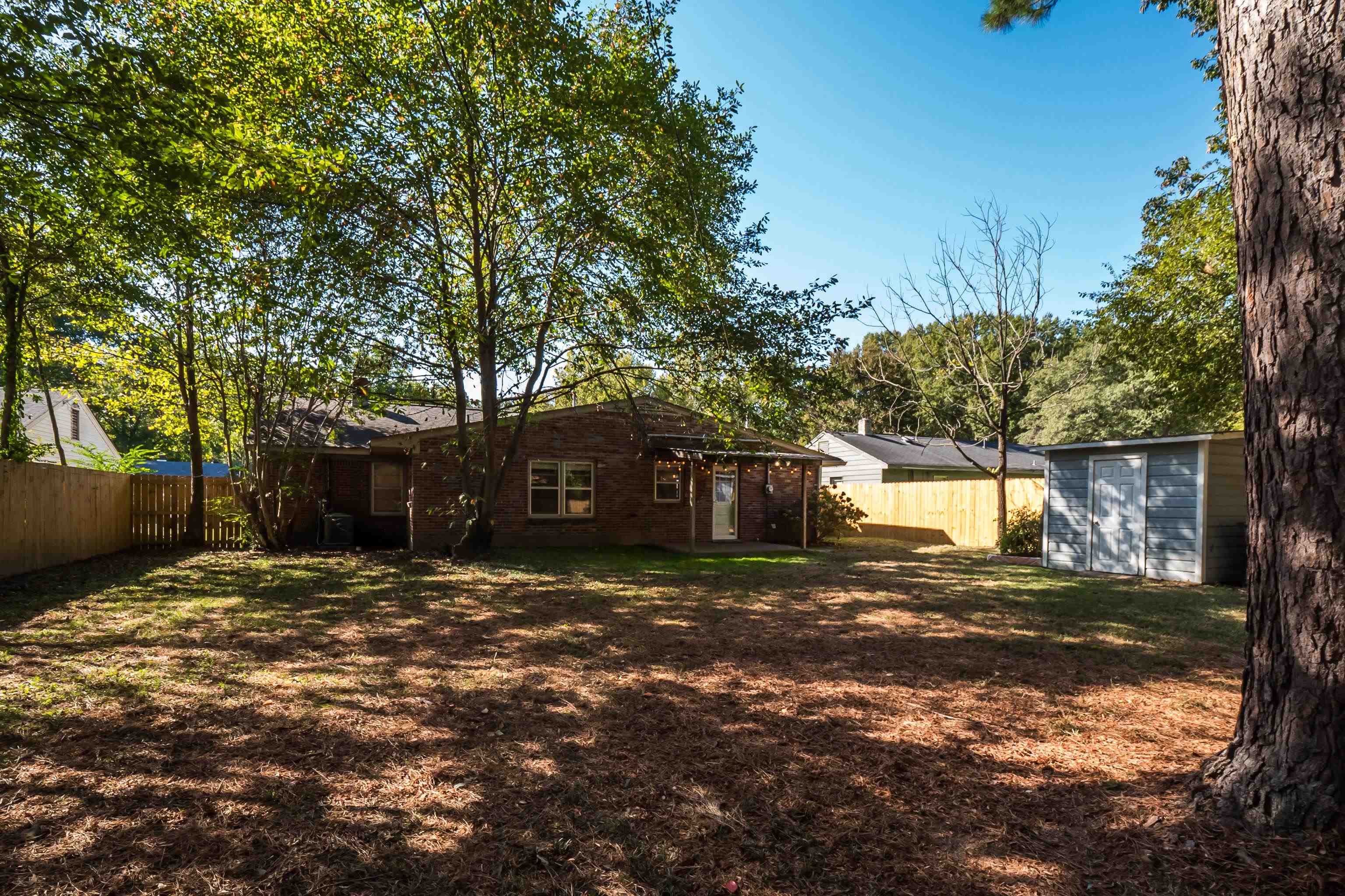 1216 West Perkins Road Memphis, TN 38117 - Photo 30 of 30 a view of a backyard with a large tree