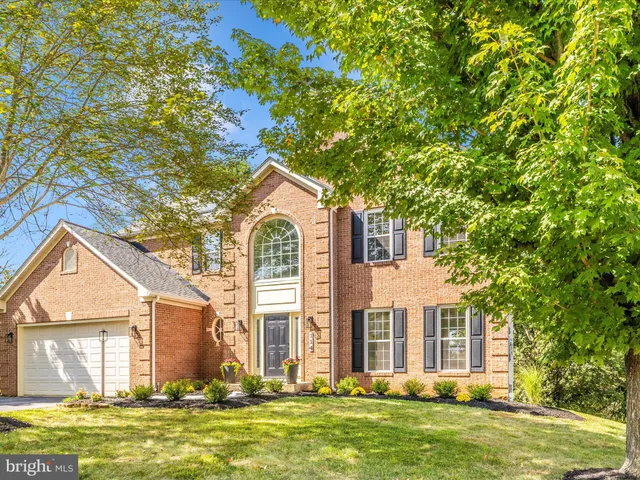 a front view of a house with a garden and yard