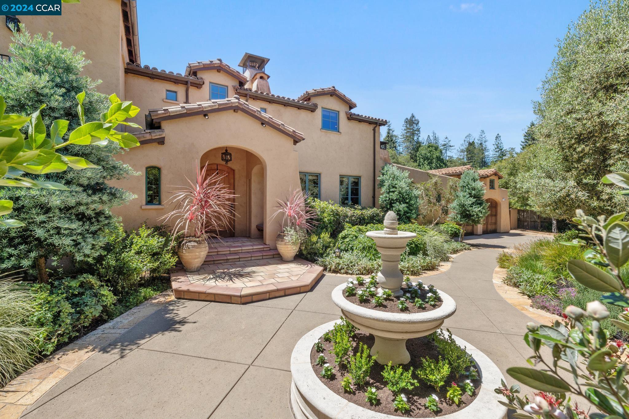 a view of a house with fountain in a patio