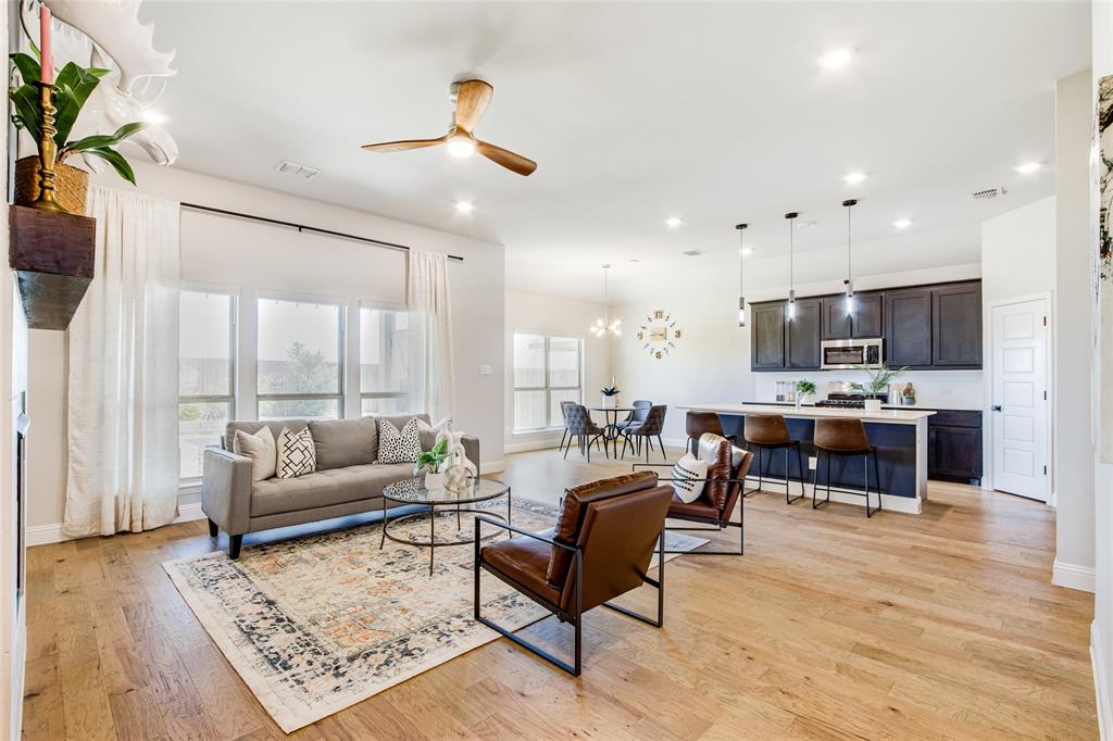 a living room with furniture and kitchen view