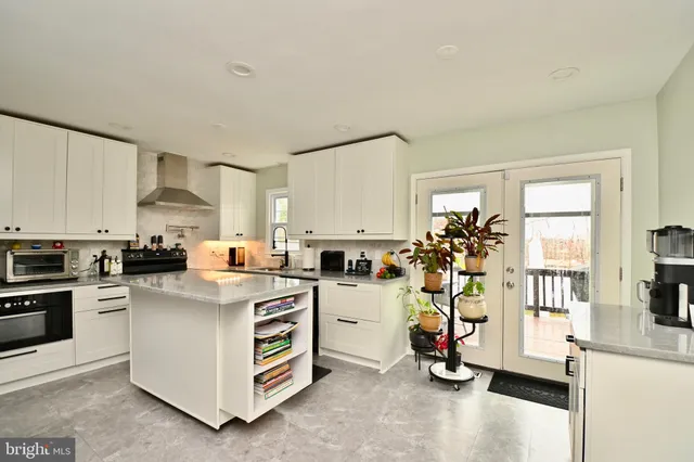 a view of a kitchen with fridge and workspace