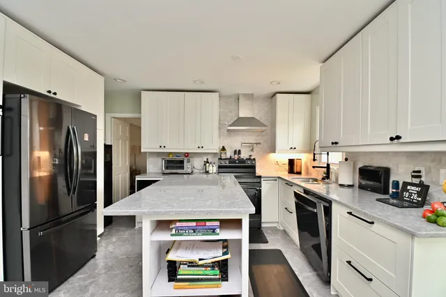a kitchen with stainless steel appliances a stove refrigerator sink and cabinets