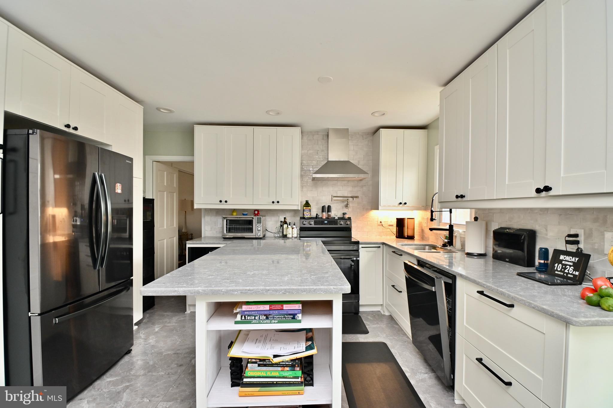 6431 Forest Road Landover, MD 20785 - Photo 12 of 42 a kitchen with stainless steel appliances a stove refrigerator sink and cabinets