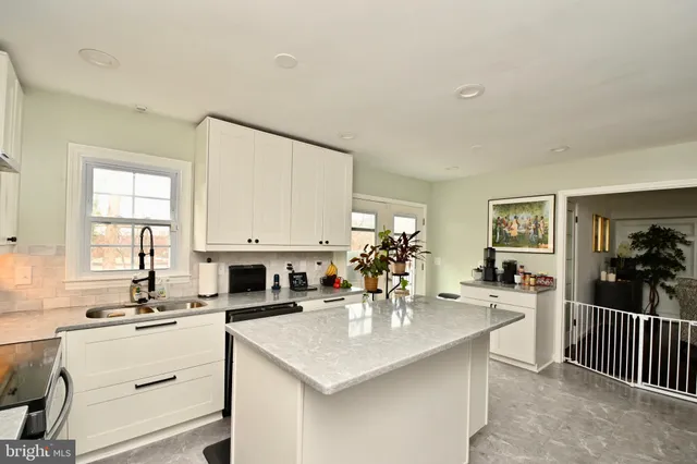 a kitchen with counter top space a sink cabinets and appliances