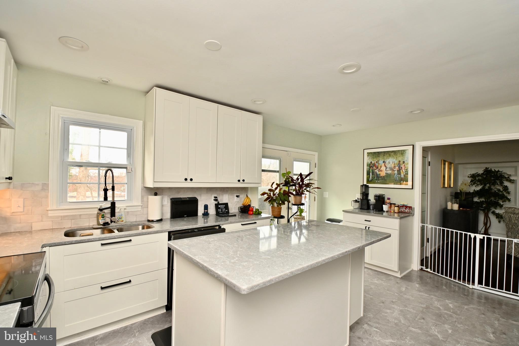 6431 Forest Road Landover, MD 20785 - Photo 14 of 42 a kitchen with counter top space a sink cabinets and appliances