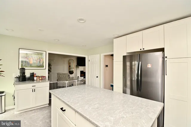 a kitchen with a refrigerator and a sink