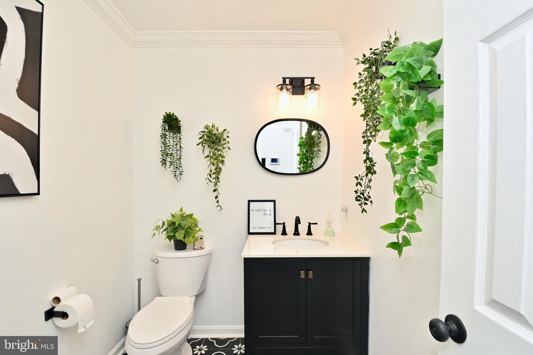 6431 Forest Road Landover, MD 20785 - Photo 16 of 42 a bathroom with a sink mirror and toilet