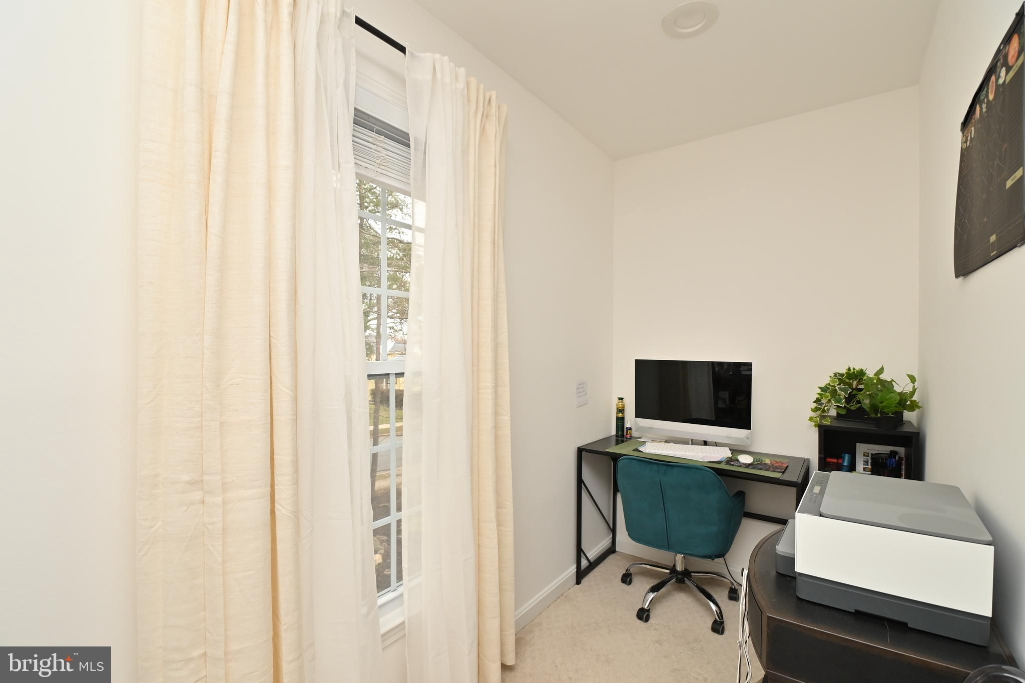 6431 Forest Road Landover, MD 20785 - Photo 18 of 42 a view of a workspace with furniture and a flat screen tv