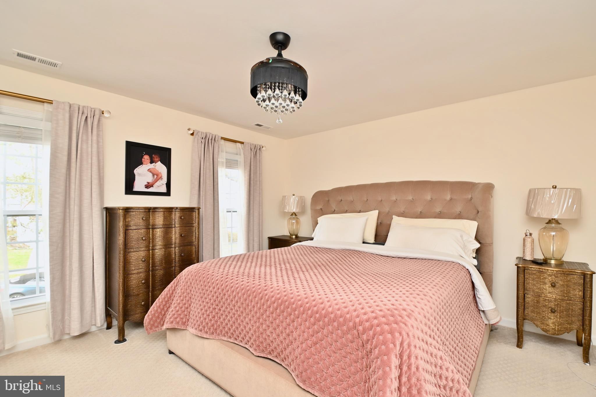 6431 Forest Road Landover, MD 20785 - Photo 19 of 42 a bedroom with a large bed and a chandelier