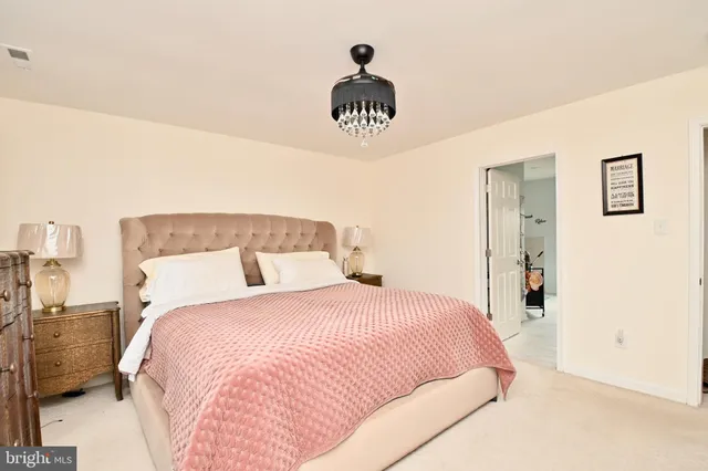 a bedroom with a bed and a lamp