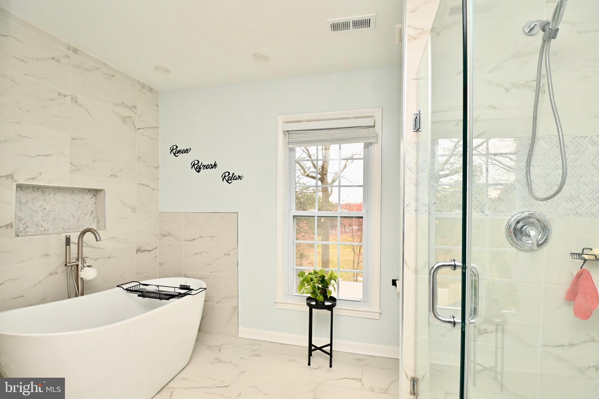 6431 Forest Road Landover, MD 20785 - Photo 24 of 42 a bathroom with a granite countertop sink a mirror a potted plant and a shower