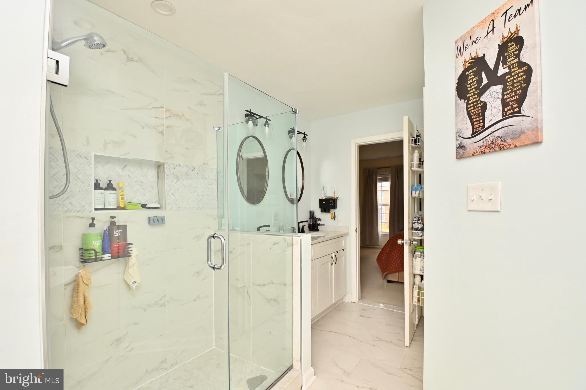 6431 Forest Road Landover, MD 20785 - Photo 25 of 42 a en suite bathroom with a sink mirror and shower