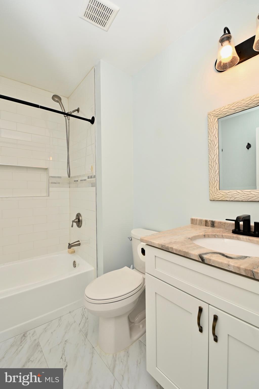 6431 Forest Road Landover, MD 20785 - Photo 30 of 42 a bathroom with a granite countertop sink a toilet and shower