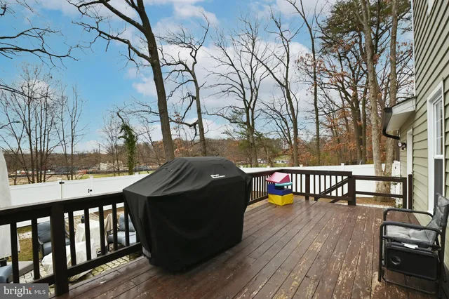 a view of a roof deck with wooden floor and fence