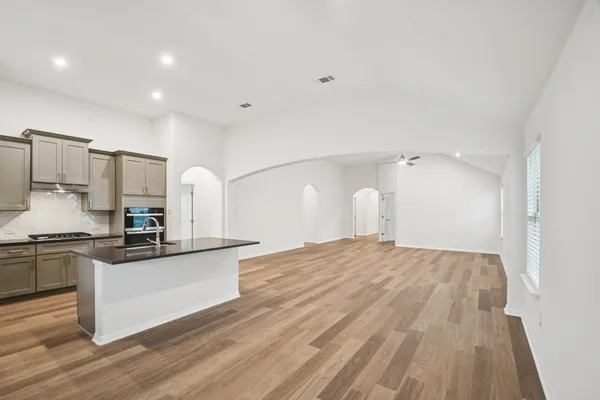 a kitchen with granite countertop a sink and steel appliances