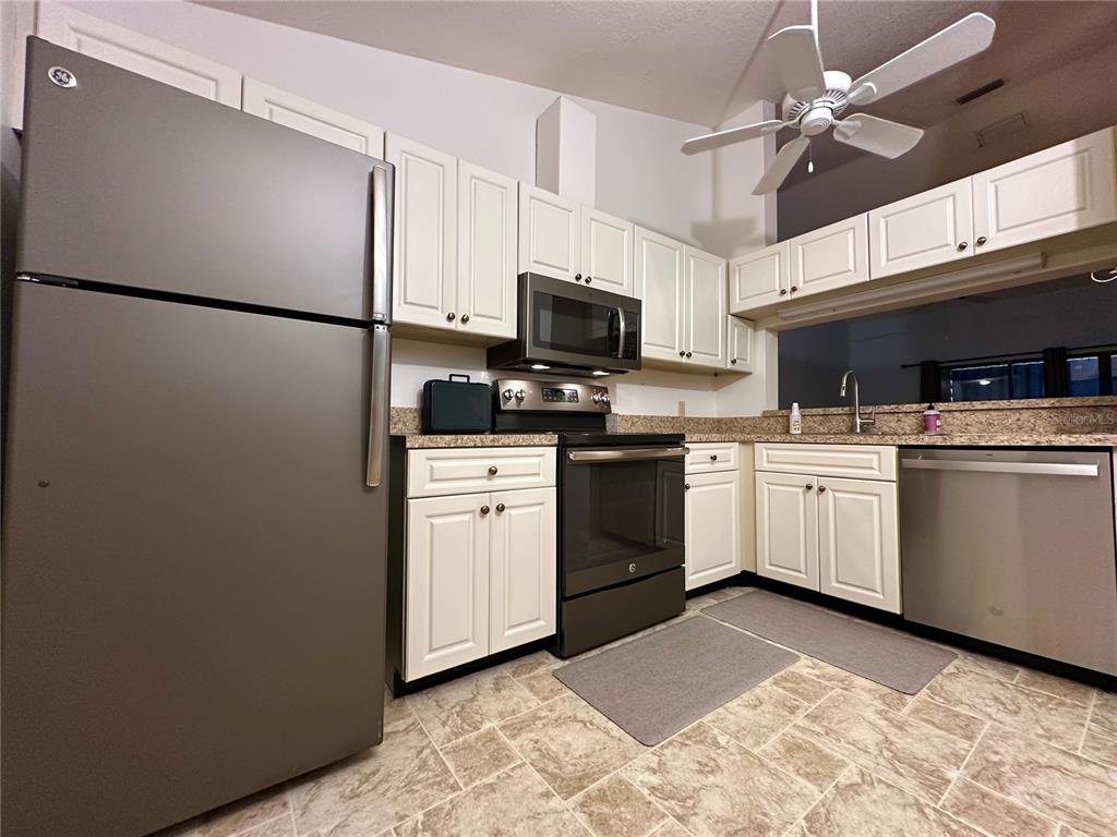 5685 Marina Drive, Unit 4 Sebastian, FL 32958 - Photo 11 of 19 a kitchen with a sink appliances and cabinets