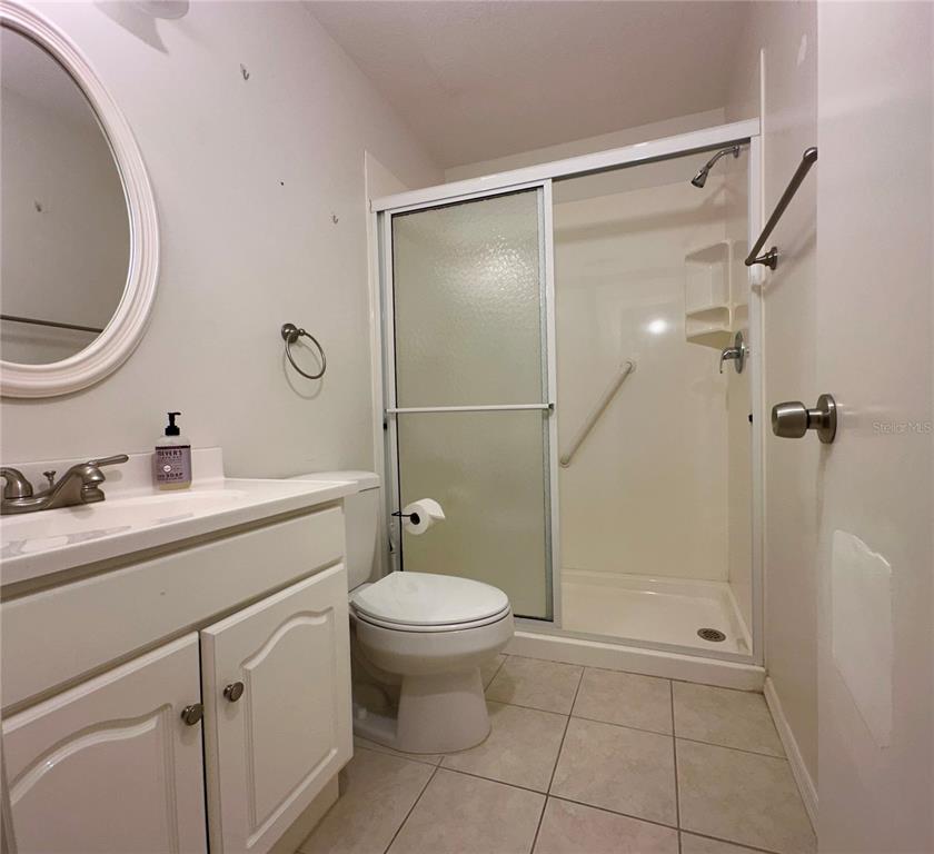 5685 Marina Drive, Unit 4 Sebastian, FL 32958 - Photo 15 of 19 a bathroom with a granite countertop sink toilet a mirror and shower