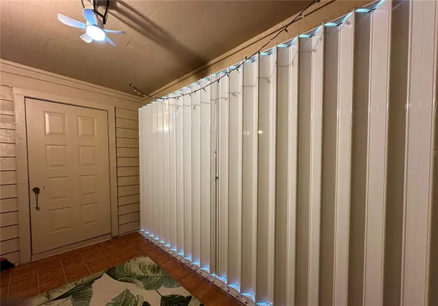 a view of wooden closet with rug