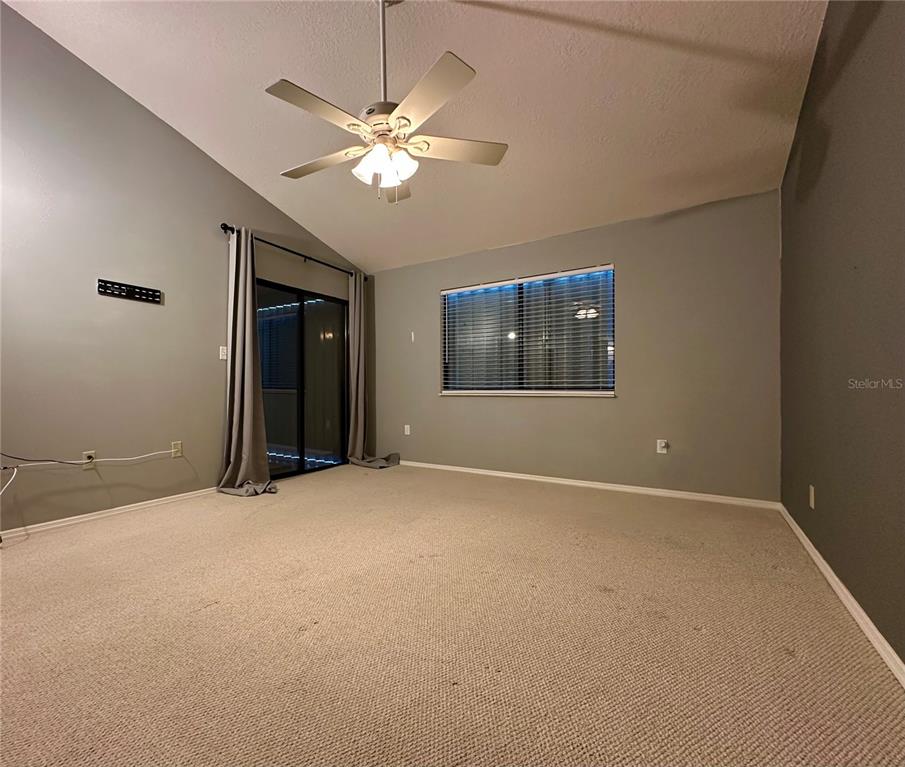 5685 Marina Drive, Unit 4 Sebastian, FL 32958 - Photo 7 of 19 an empty room with chandelier fan and windows