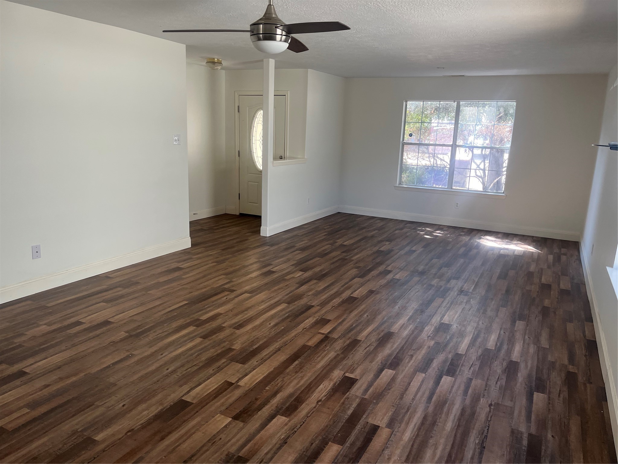 19638 Perth Meadows Court Katy, TX 77449 - Photo 13 of 13 an empty room with wooden floor a ceiling fan and windows