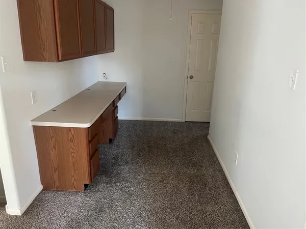 a kitchen with sink a microwave and cabinets