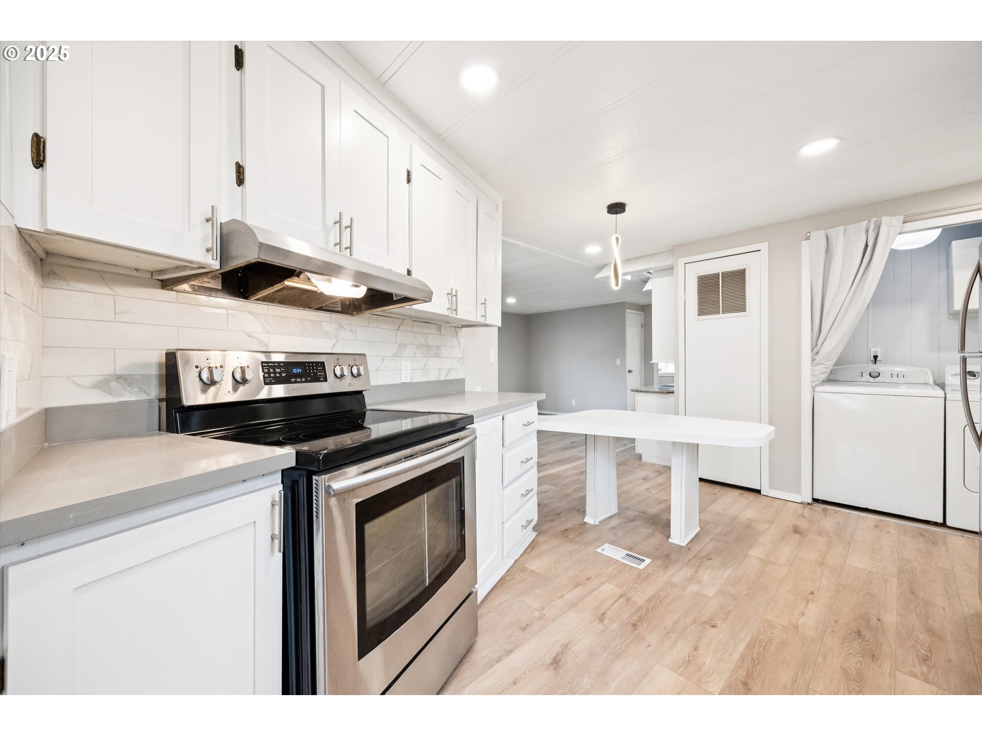 10701 Southeast Highway 212, Unit P6 Clackamas, OR 97015 - Photo 13 of 42 a kitchen with stainless steel appliances granite countertop a sink a stove a refrigerator and white cabinets