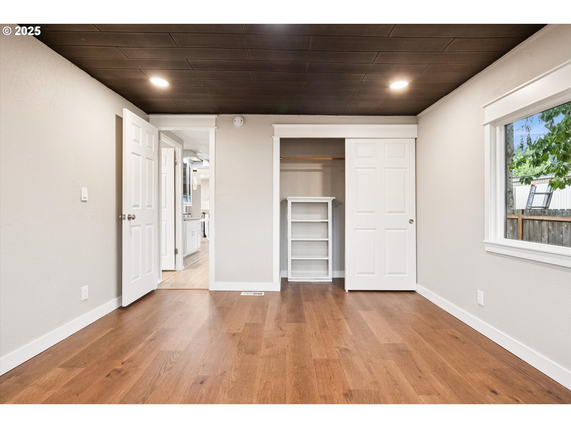 10701 Southeast Highway 212, Unit P6 Clackamas, OR 97015 - Photo 18 of 42 a view of an empty room with wooden floor and windows