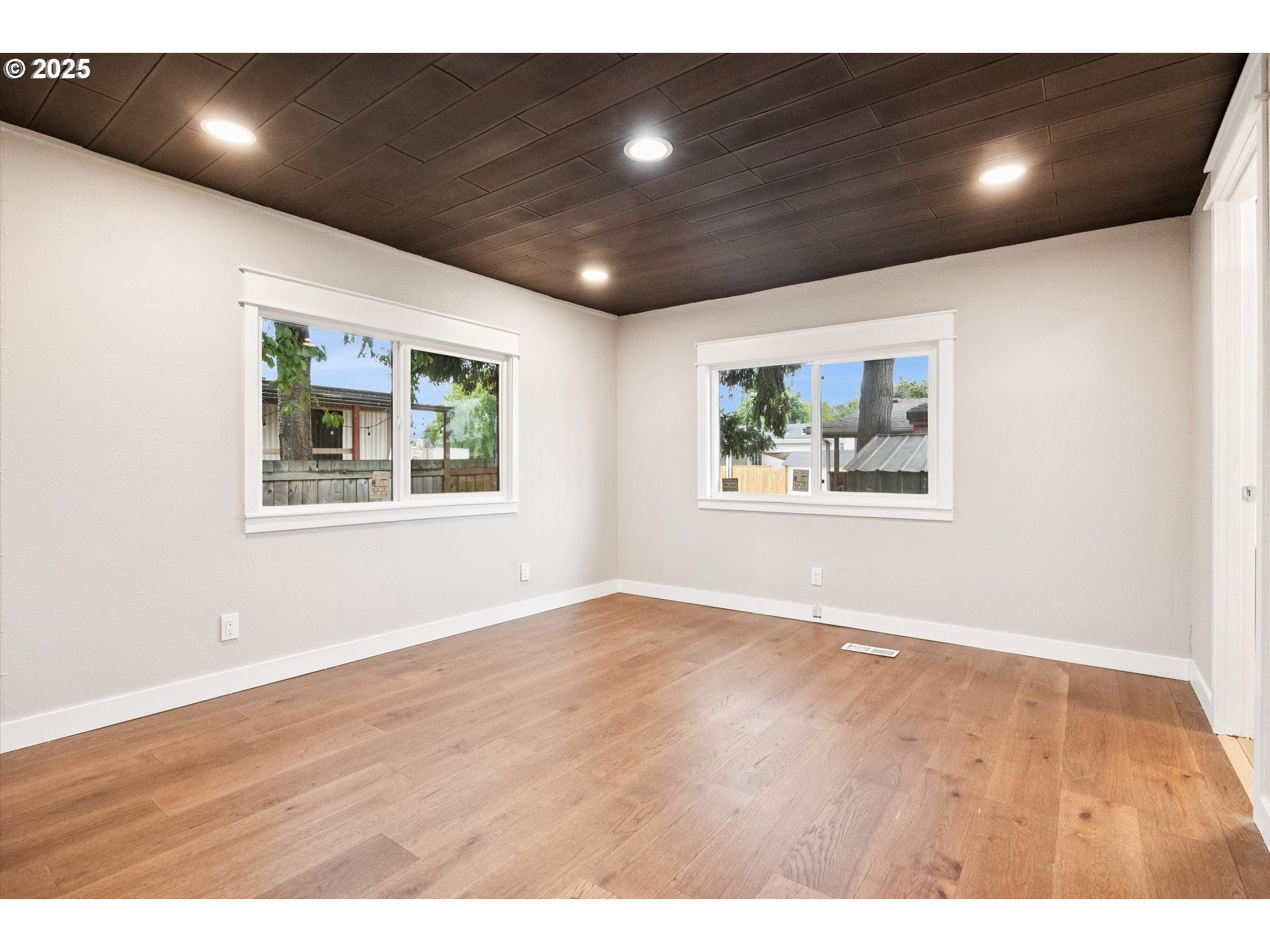 10701 Southeast Highway 212, Unit P6 Clackamas, OR 97015 - Photo 19 of 42 an empty room with wooden floor and windows