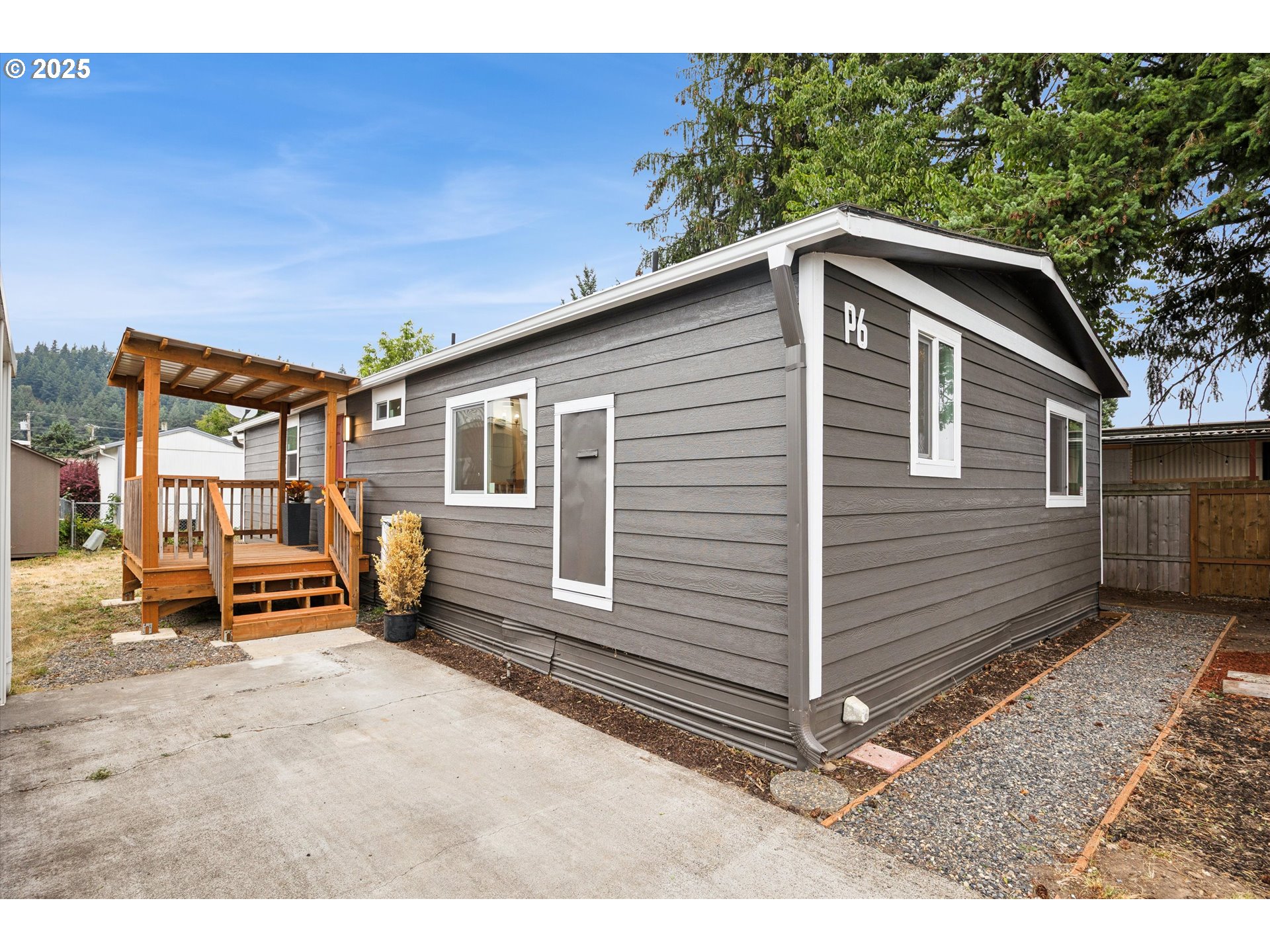 10701 Southeast Highway 212, Unit P6 Clackamas, OR 97015 - Photo 2 of 42 a front view of a house with a yard