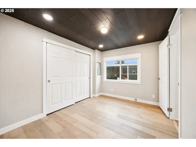 a bathroom with a granite countertop toilet sink and mirror