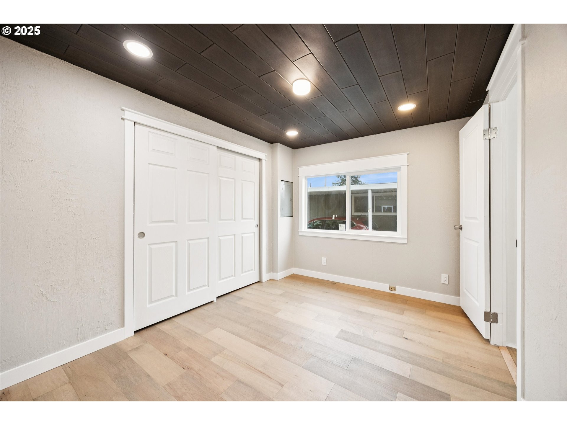 10701 Southeast Highway 212, Unit P6 Clackamas, OR 97015 - Photo 24 of 42 a view of an empty room with wooden floor and windows